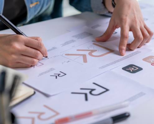 Graphic designer drawing sketches logo design. The concept of a